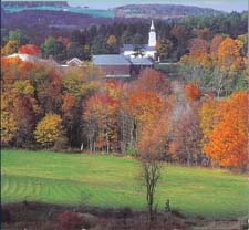 Vibrant autumn foliage surrounds a New England village.