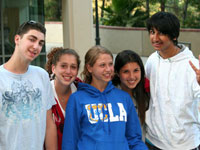 A group of smiling teenagers poses for a photo.